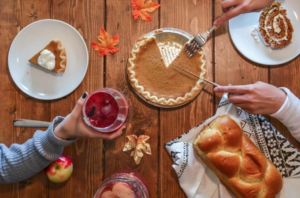above shot of a thanksgiving dinner table with pumpkin pie