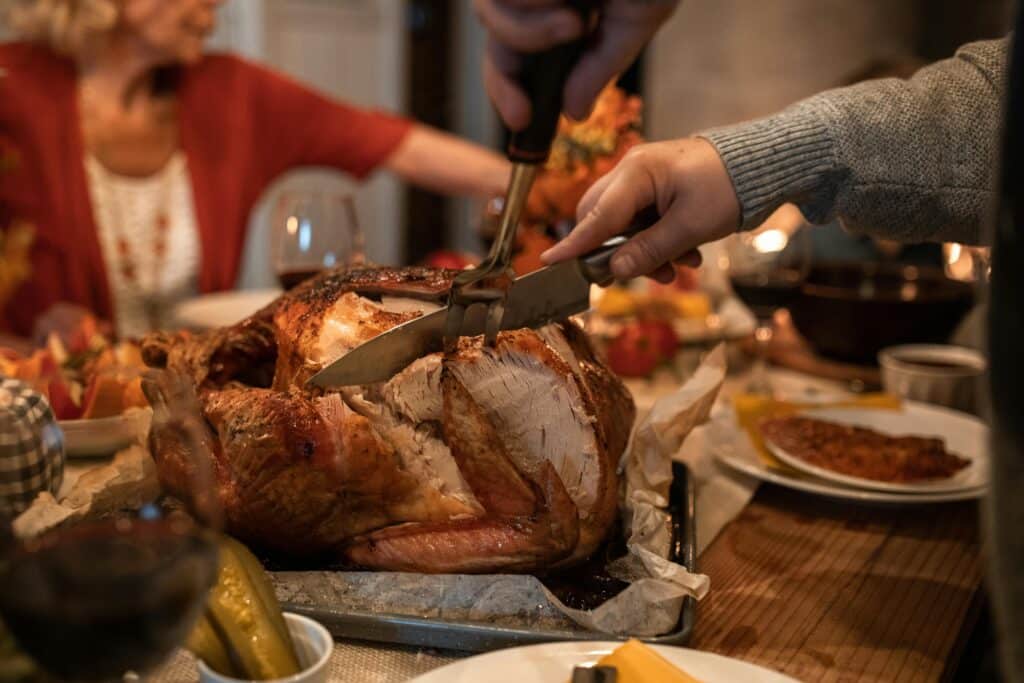 Thanksgiving dinner with a turkey being cut into